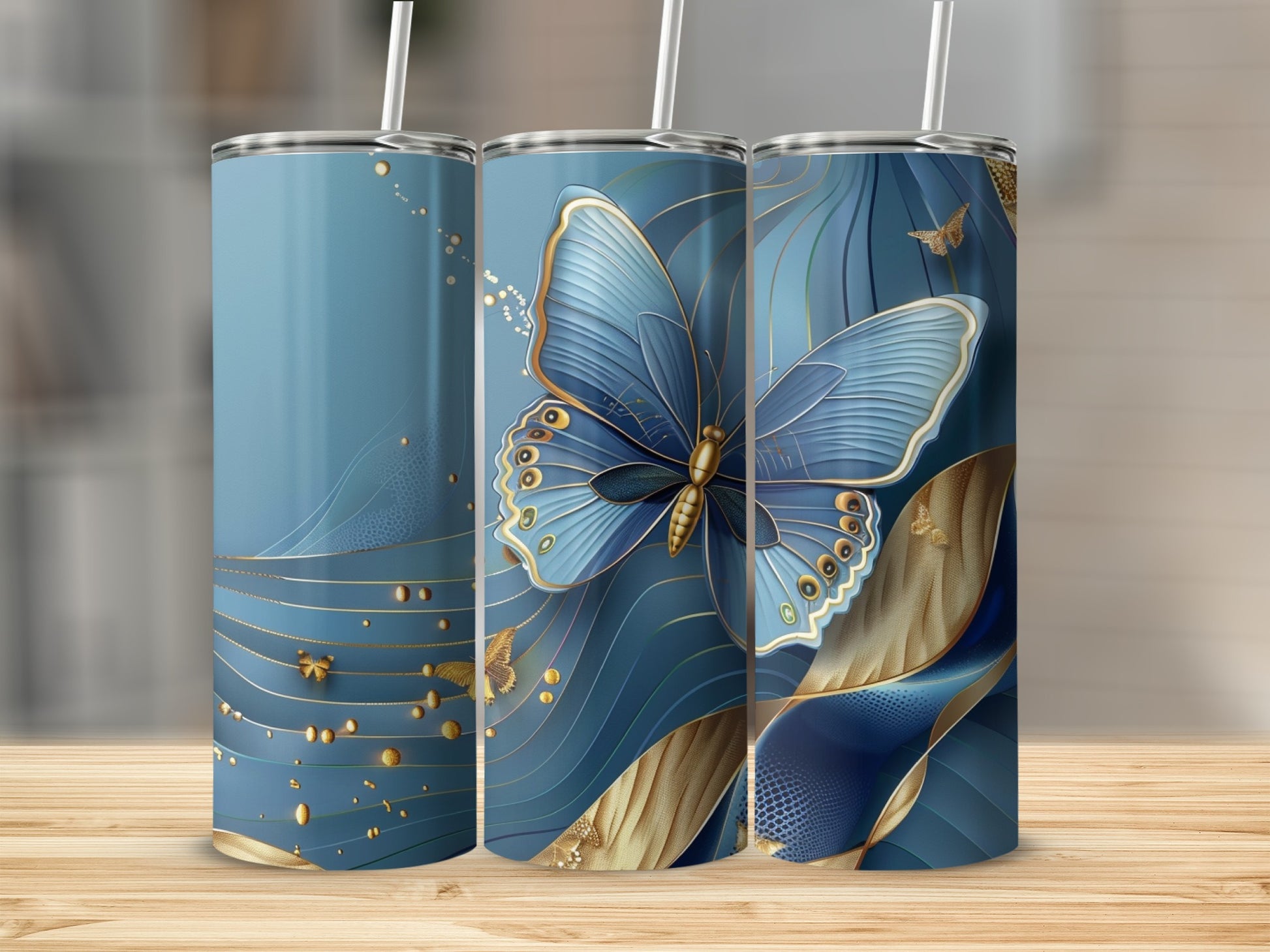 Three blue tumblers featuring golden butterflies and abstract wavy designs.