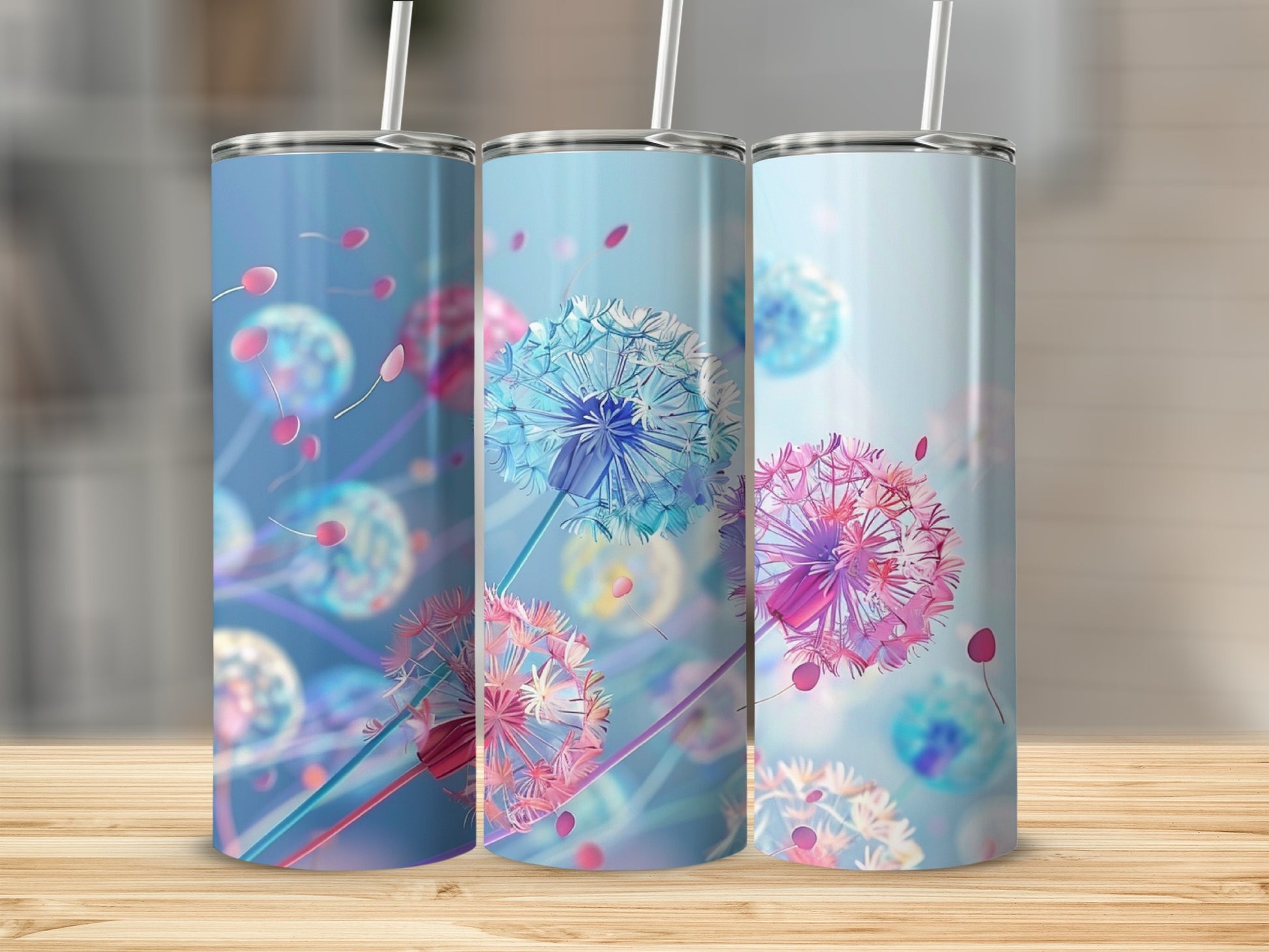 Three tumblers with dandelion seed designs in blue, pink, and purple.