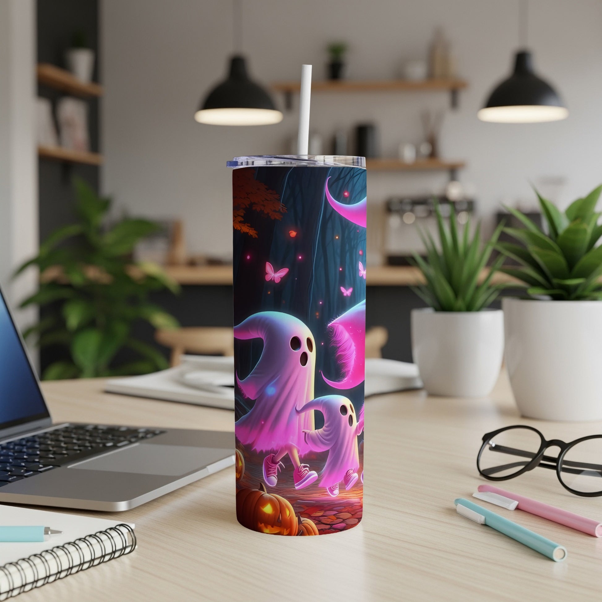 Tumbler with cartoon ghosts, pumpkins, and butterflies in a dark forest.