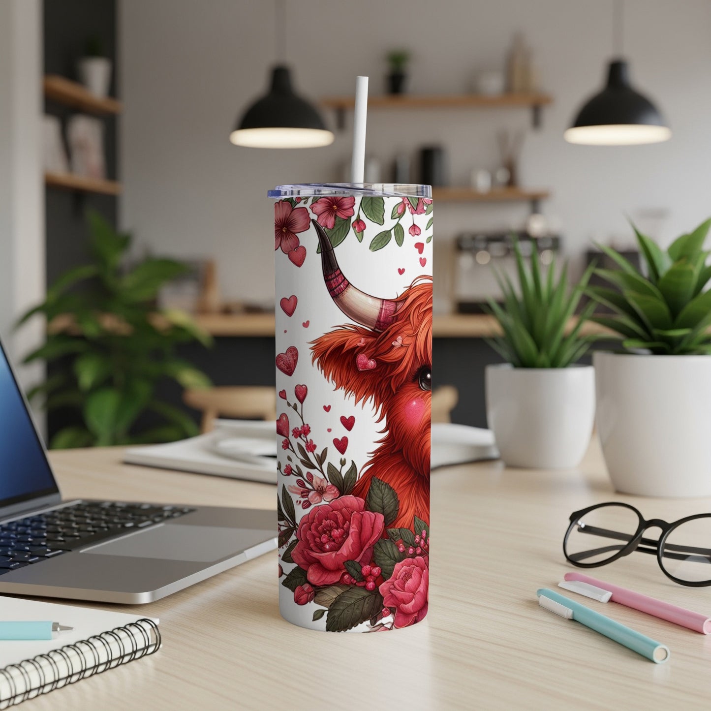 Highland cow illustration on a white tumbler with red flowers and hearts.