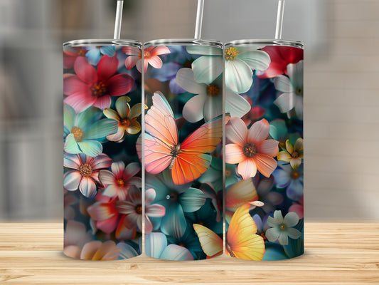 Three tumblers with colorful floral and butterfly designs on a wooden surface.