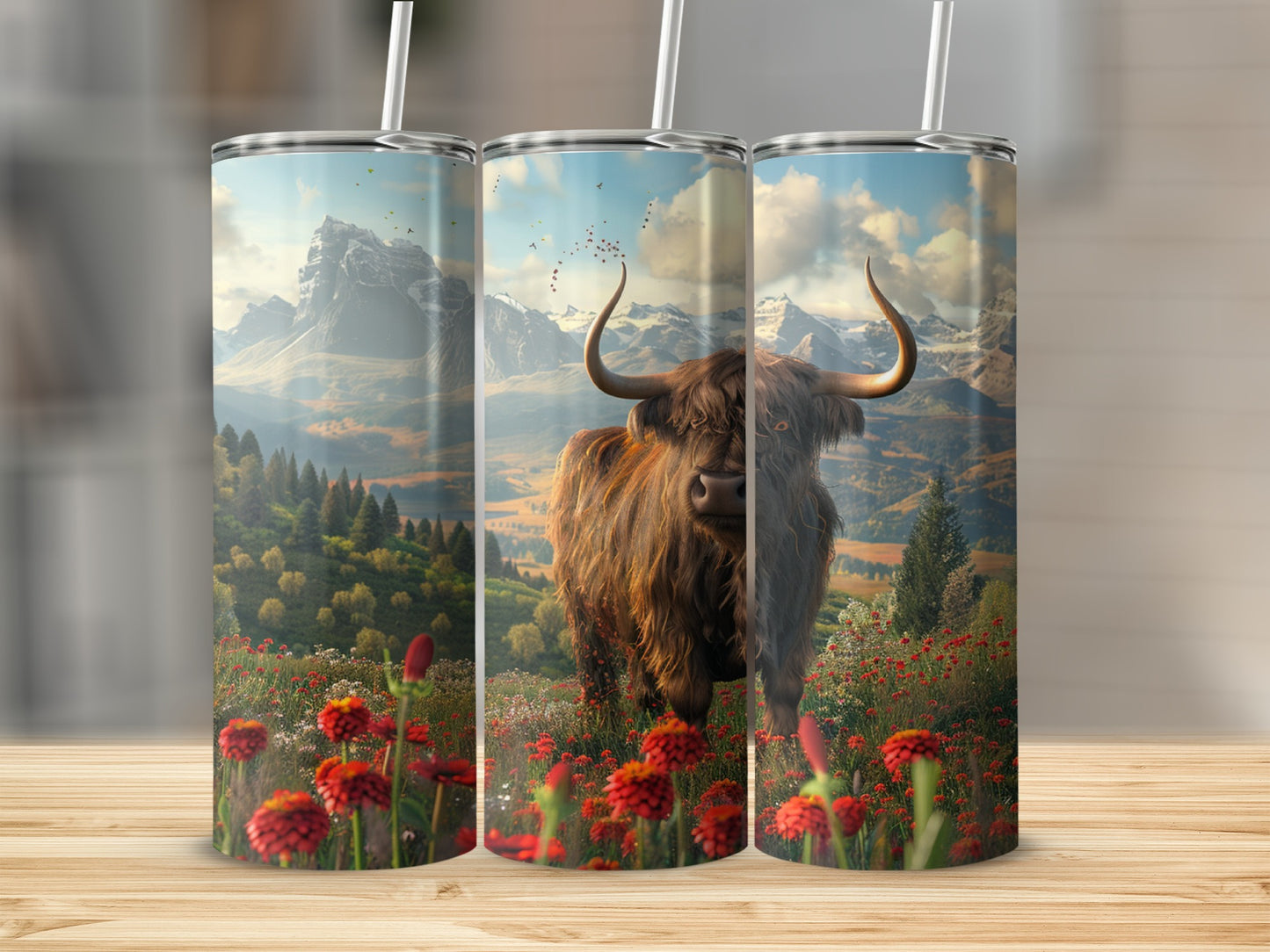 Highland cow in a field of red flowers with mountains in the background.