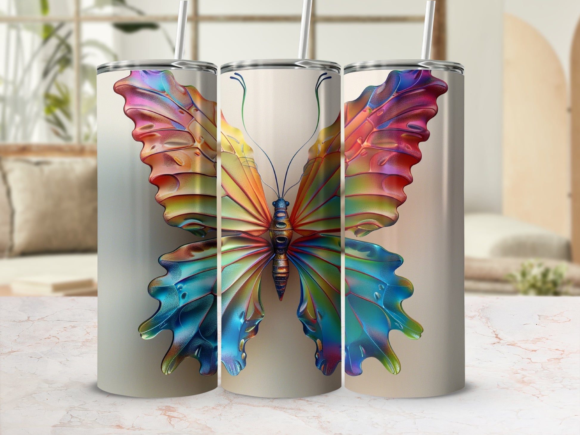 Three tumblers featuring a vibrant, multi-colored butterfly design.