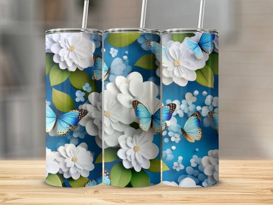 Blue butterfly and white flower patterned tumblers on a wooden surface.