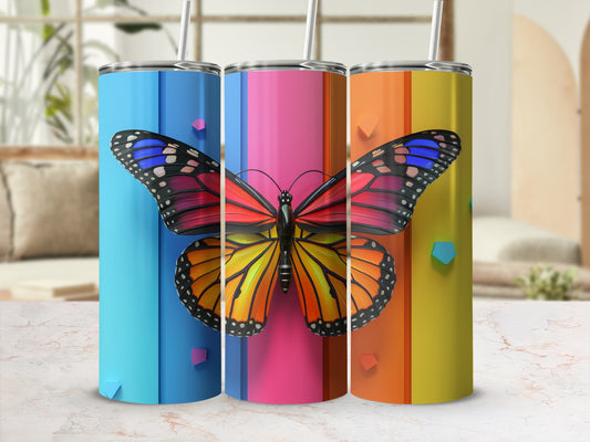 Three colorful tumblers with a butterfly design stand in a row.