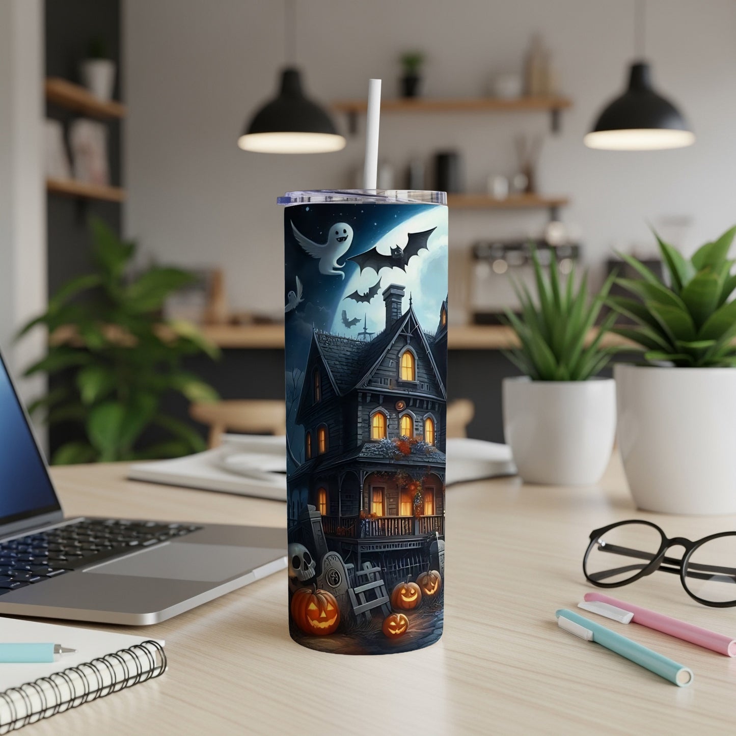 Tumbler with a spooky haunted house, ghosts, bats, pumpkins, and a graveyard scene.