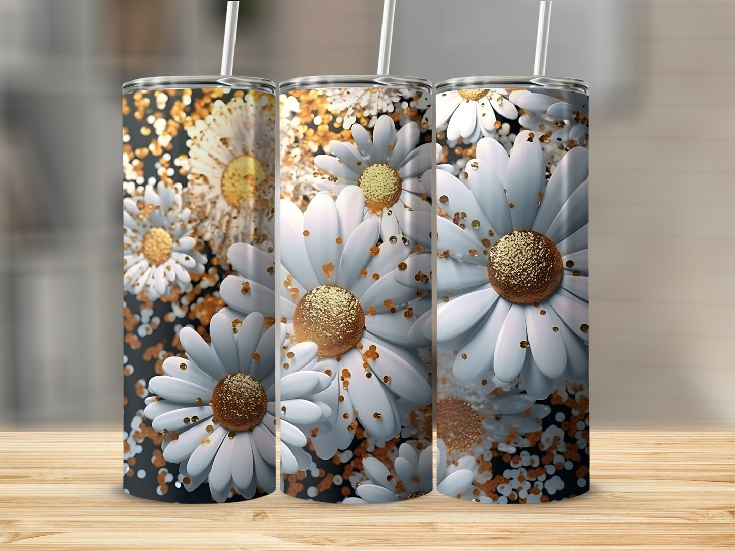 Three tumblers with white daisies and gold glitter accents on a wooden surface.