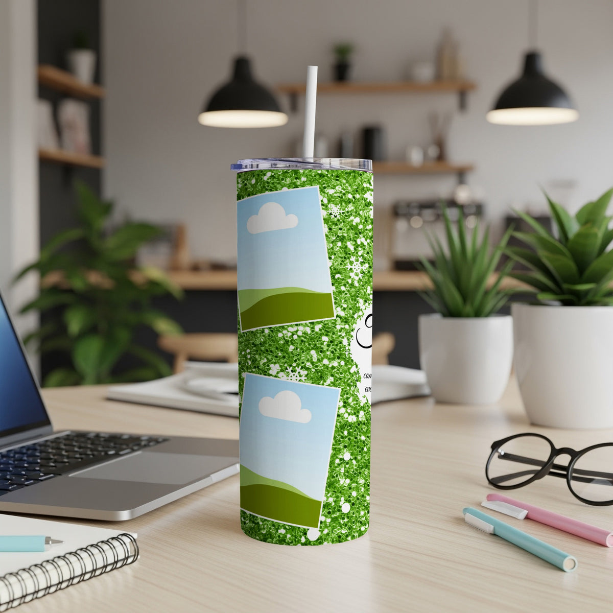 Green glitter tumbler with photo inserts and text on a desk.