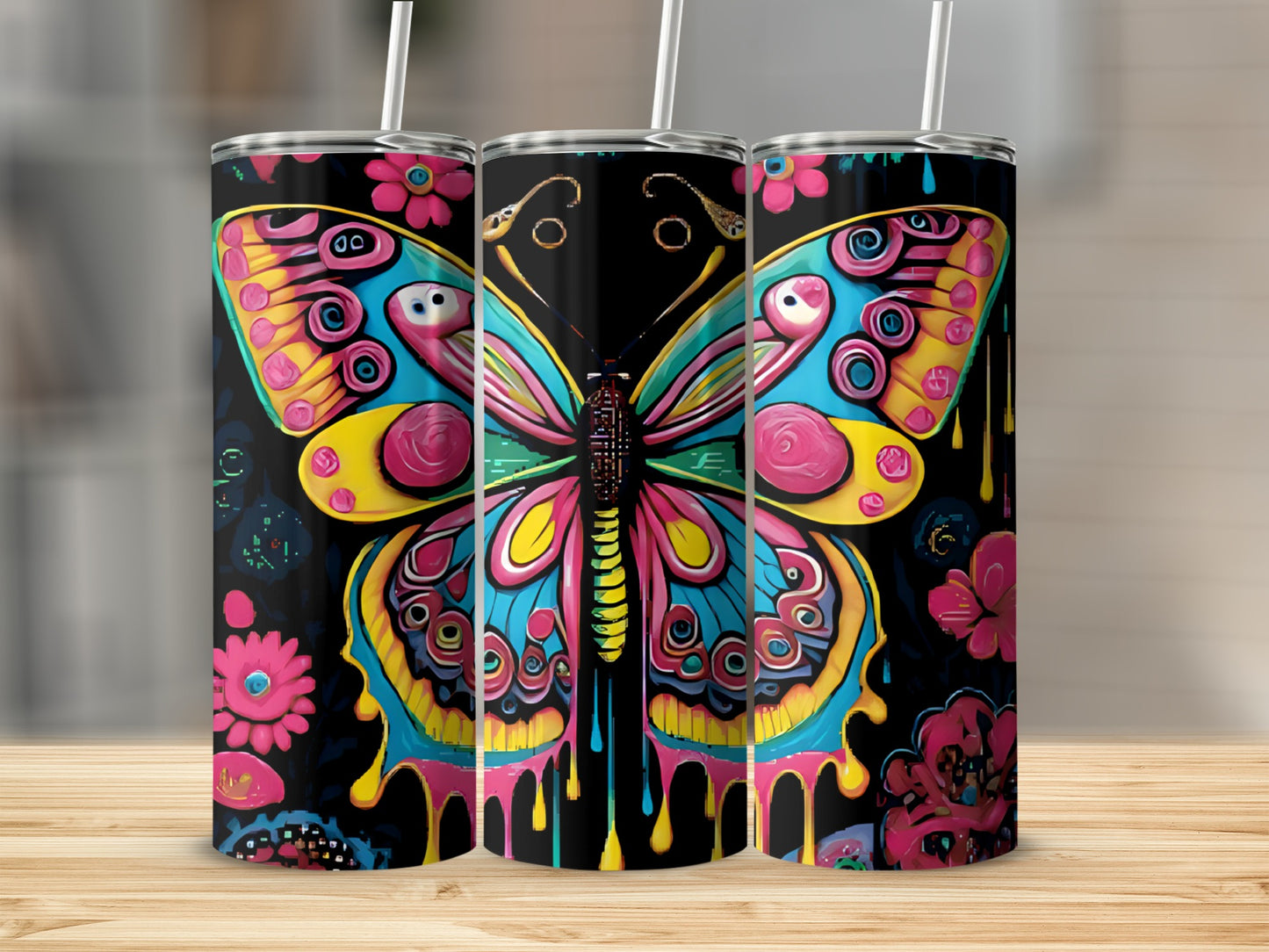 Three tumblers with colorful butterfly and flower designs.