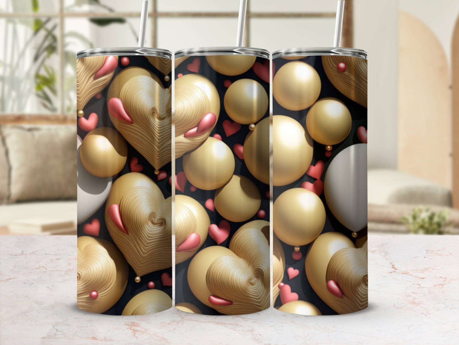 Three tumblers with golden heart and sphere pattern on black background.