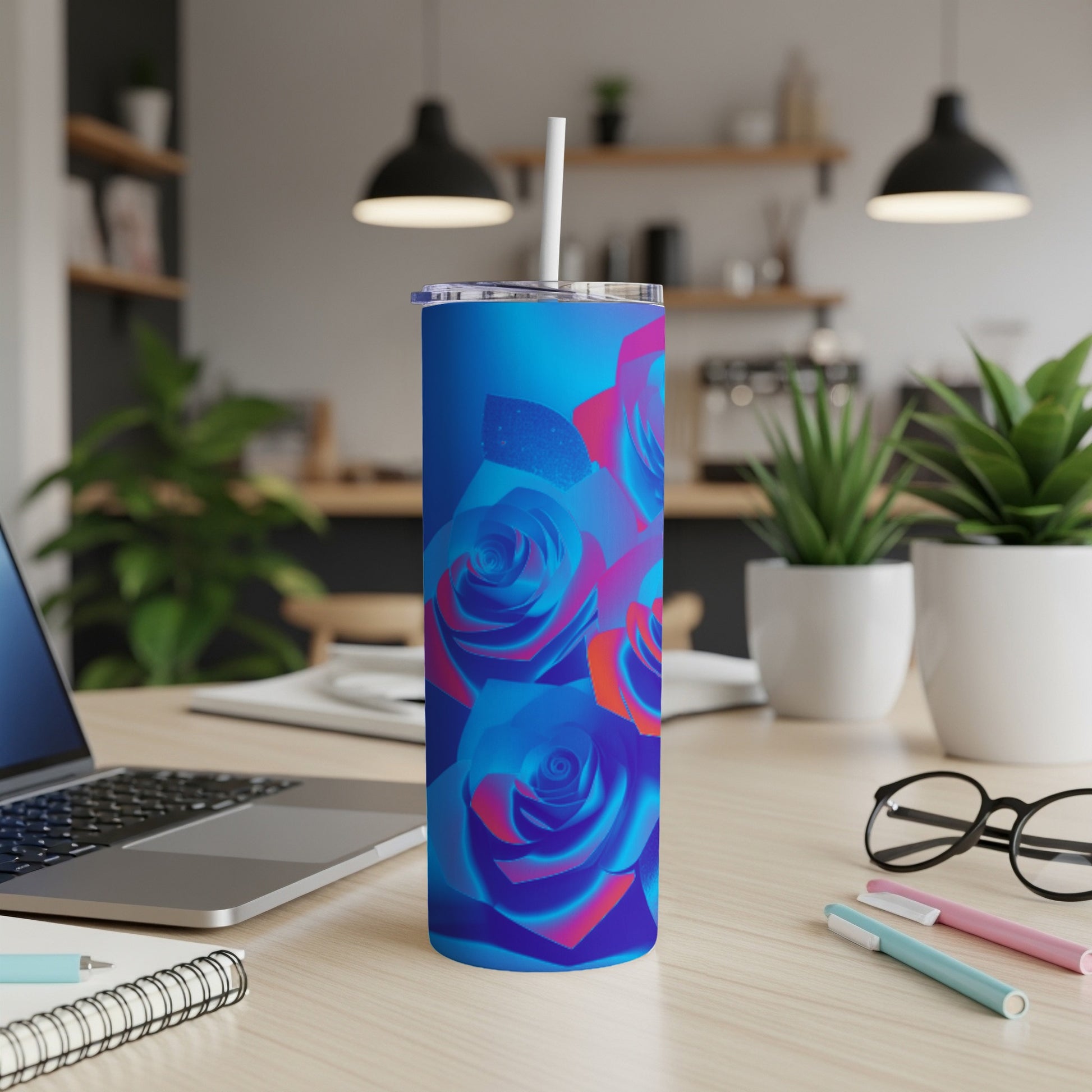 Blue and pink abstract roses on a blue gradient tumbler with a straw.