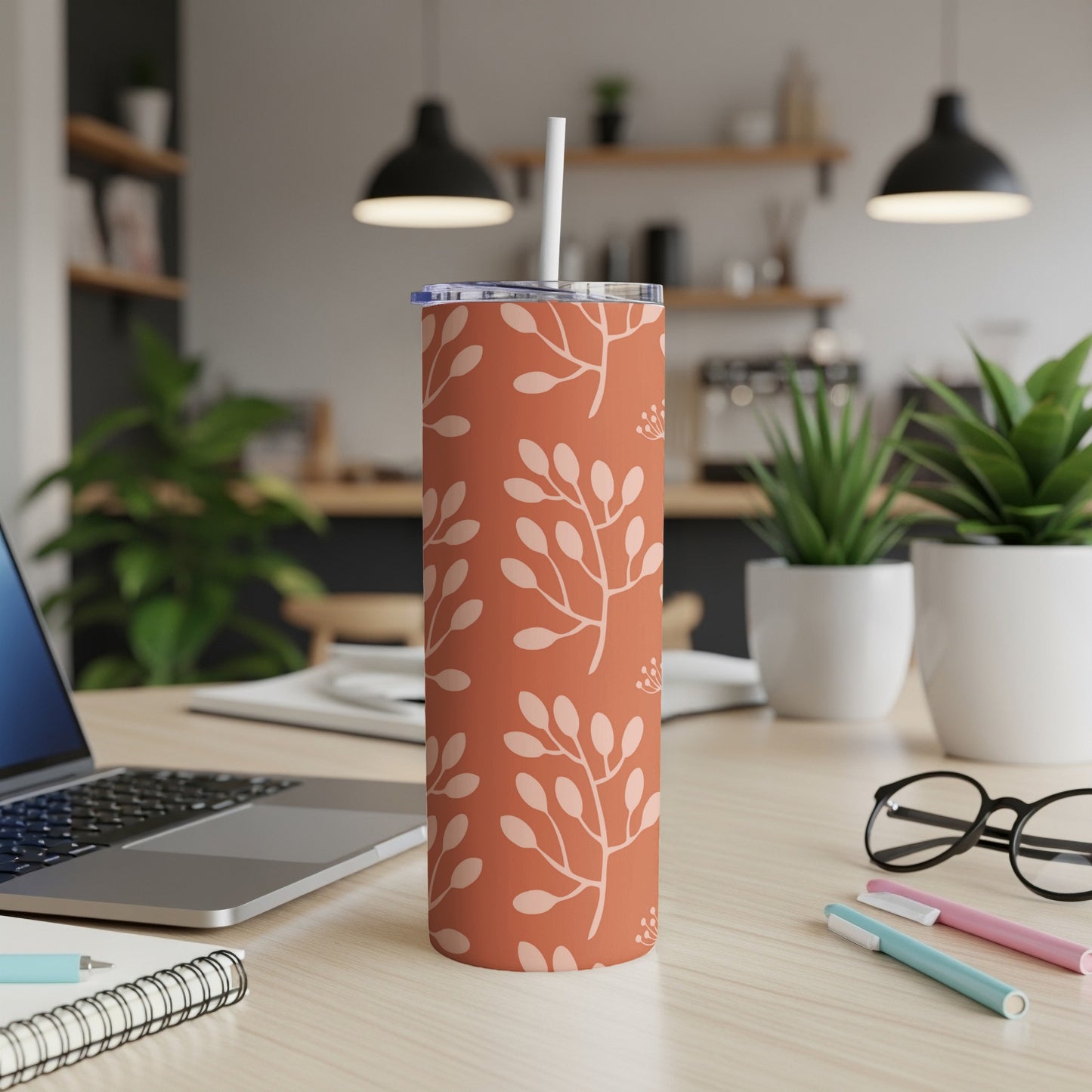 Terracotta tumbler with light pink botanical pattern and straw.
