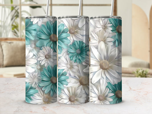 Tumbler with a floral pattern of white and teal daisy-like flowers.