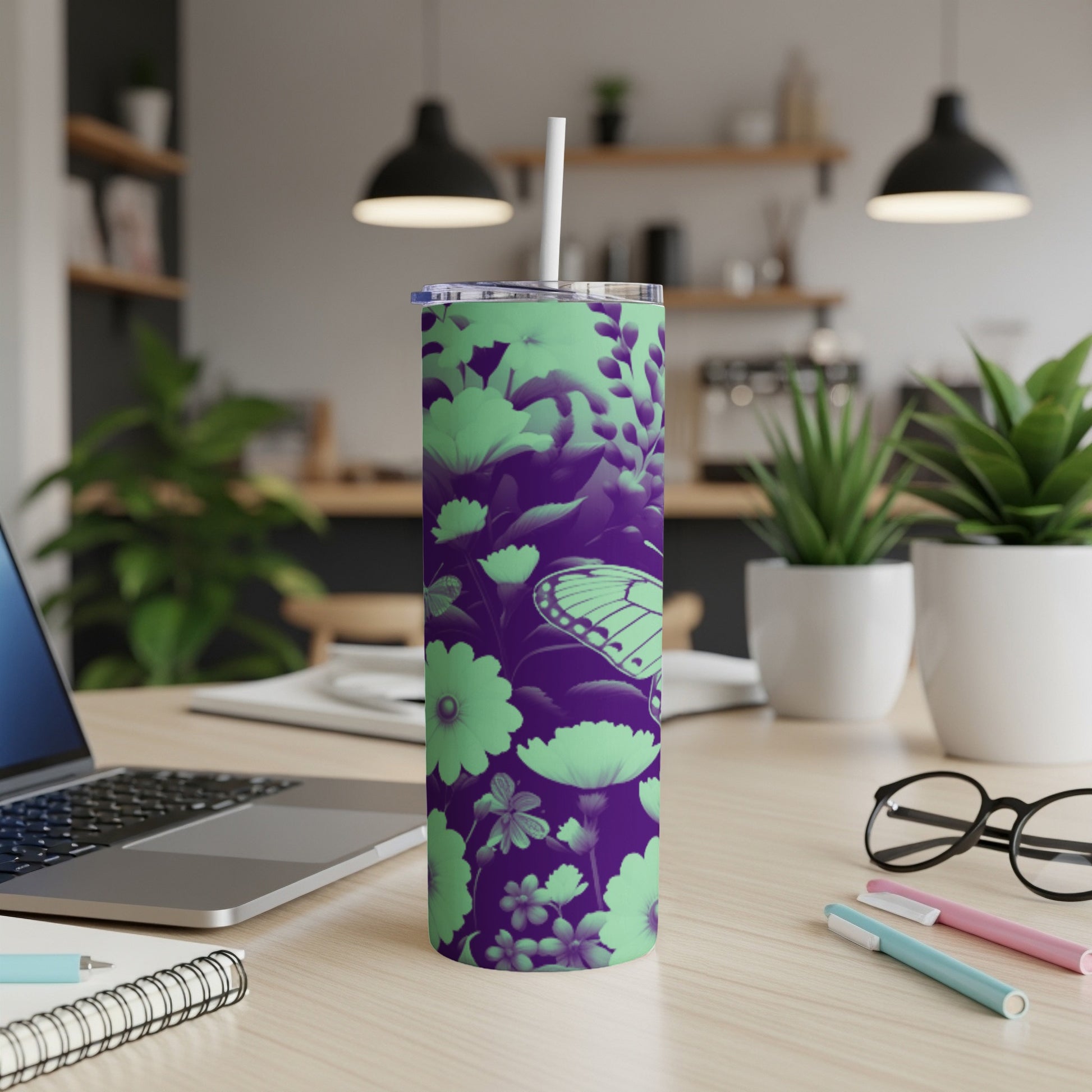 Purple tumbler with a butterfly and floral pattern, featuring a white straw.