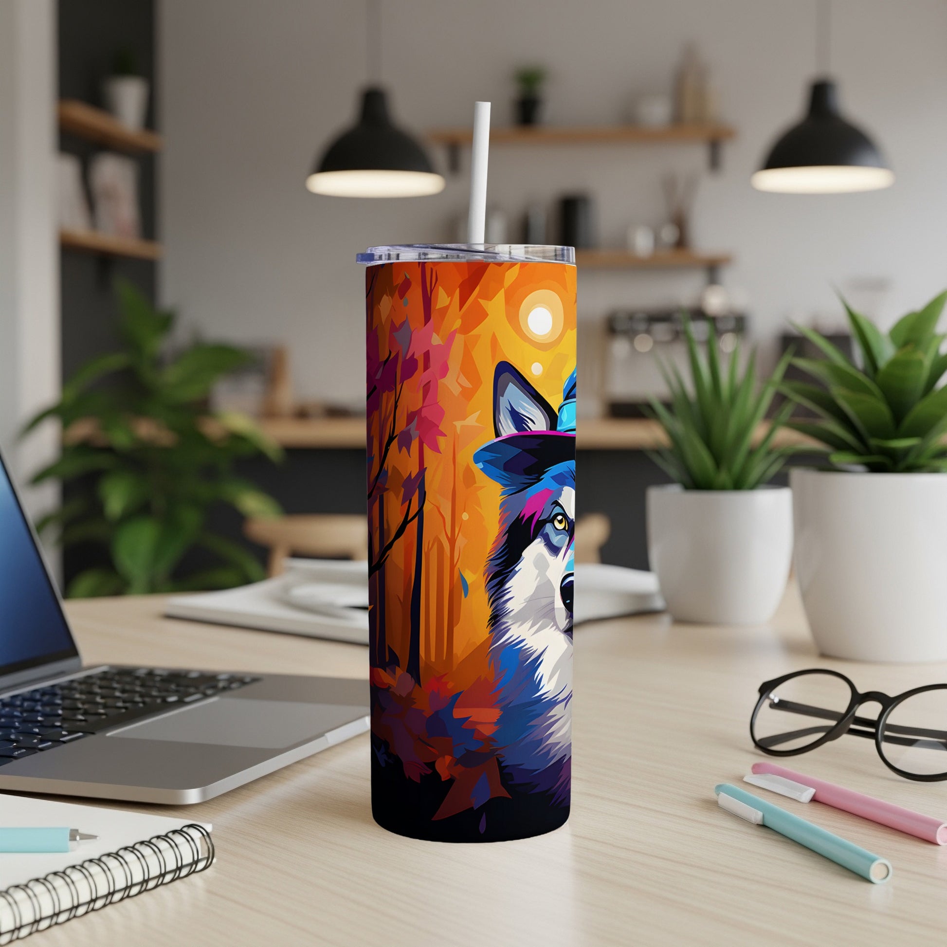 Tumbler with colorful wolf and autumn forest design, featuring a straw.