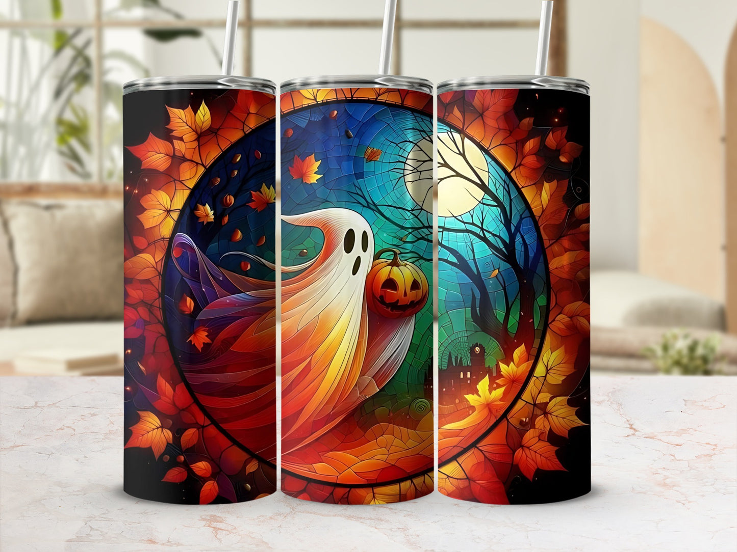 Three tumblers feature a Halloween design with a ghost, pumpkin, and haunted castle amid autumn leaves.