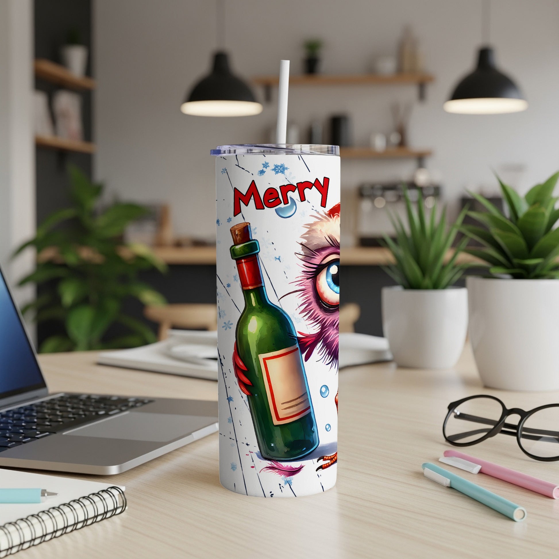 Christmas owl mug with festive design and straw, on desk with laptop.