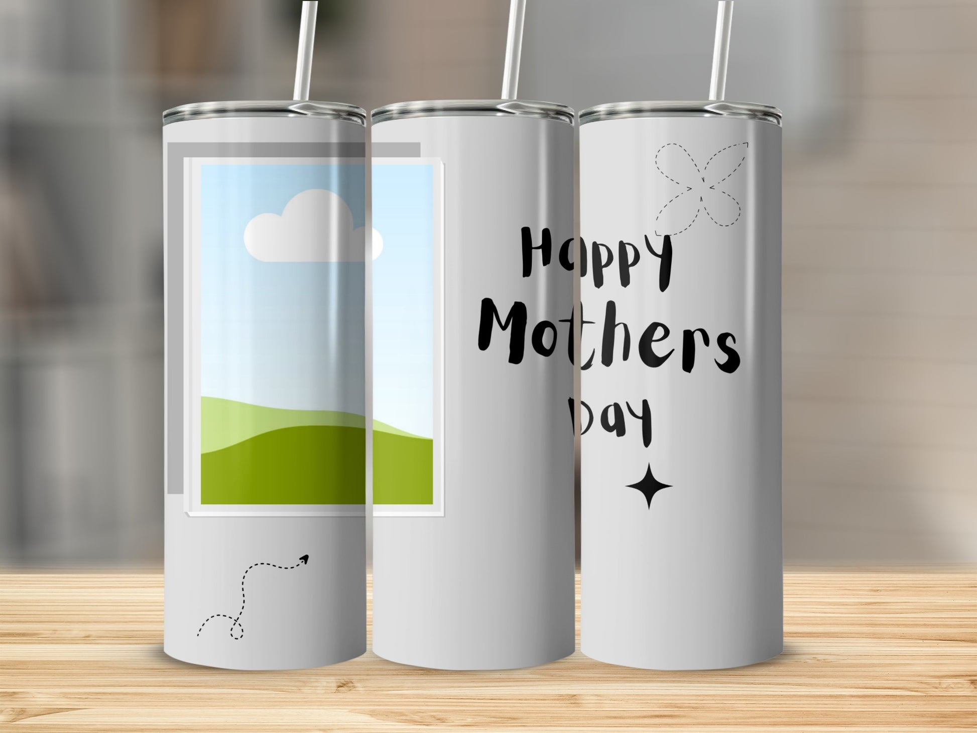 Three tumblers with straws, one features a window with a landscape, another with "Happy Mothers Day" text.