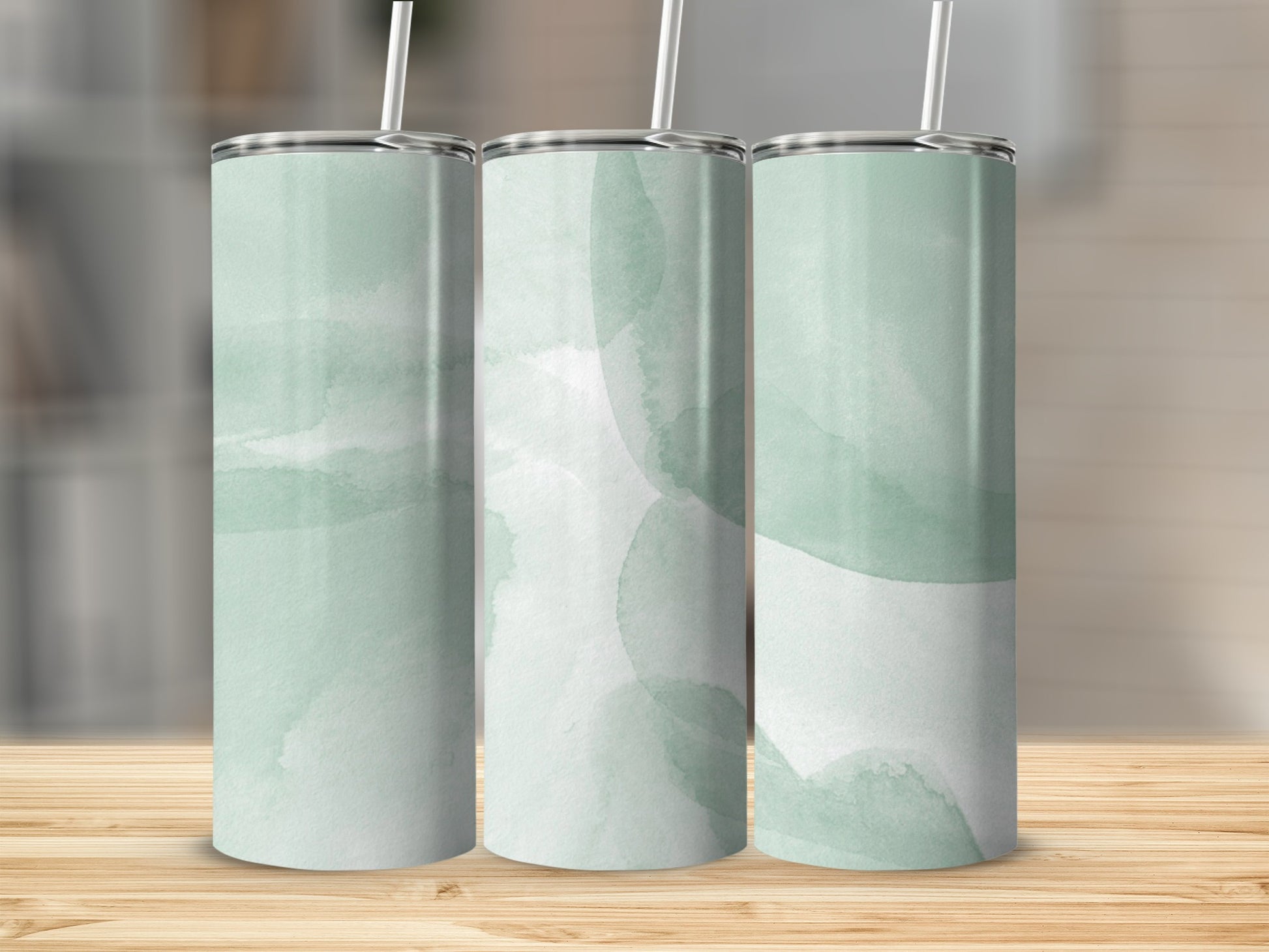 Three tall tumblers with a muted green watercolor abstract design.