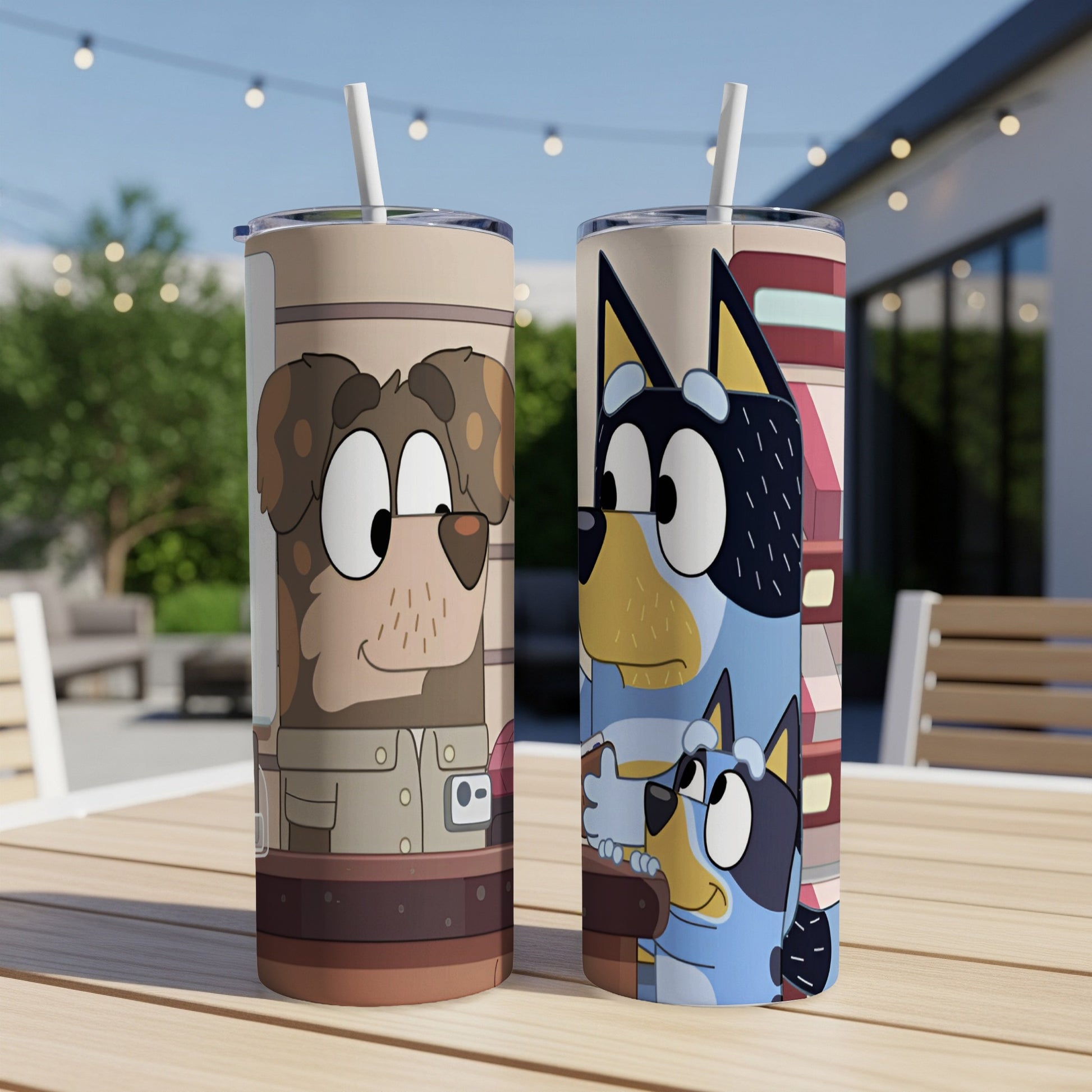 Two Bluey character tumblers with straws on a table.