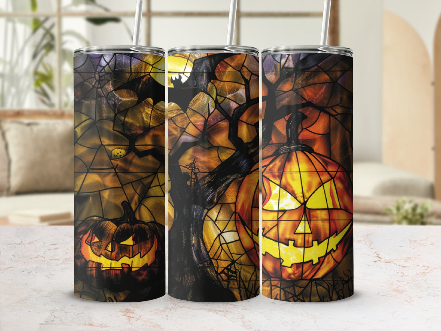 Three Halloween-themed tumblers with jack-o'-lanterns and spooky trees.