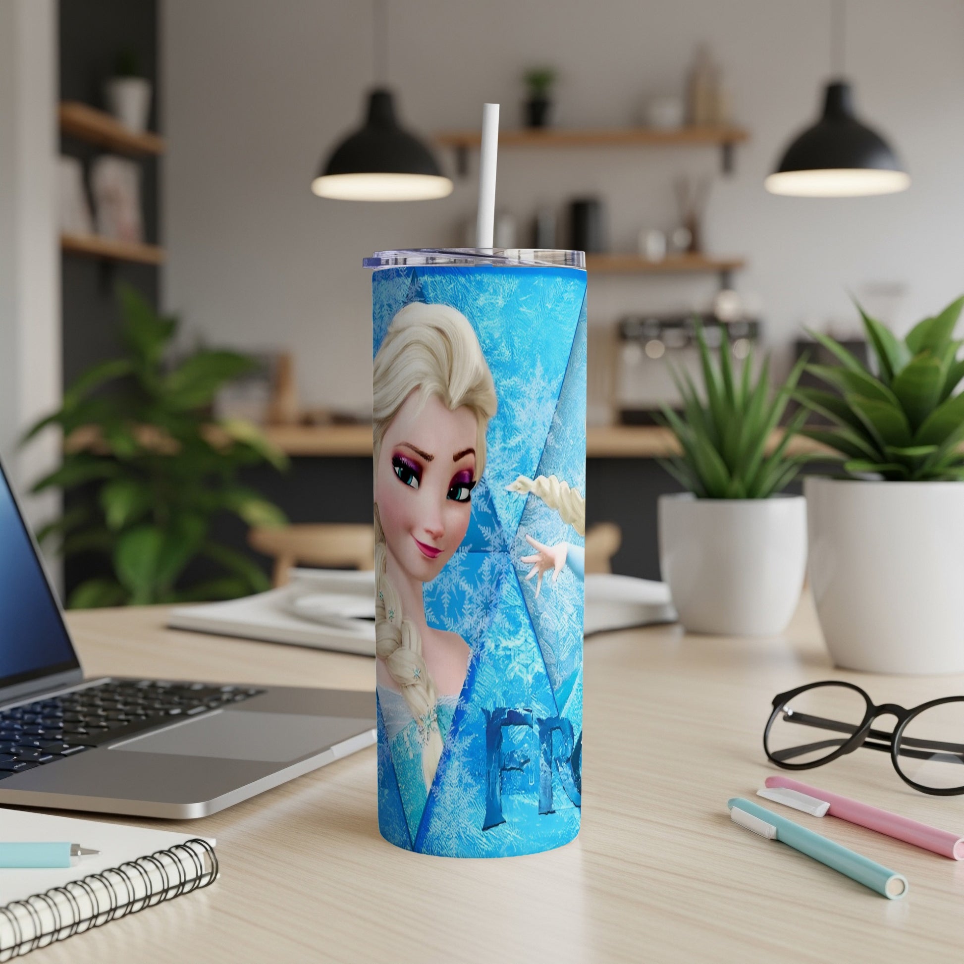 Elsa from Frozen on a blue tumbler with snowflake pattern.