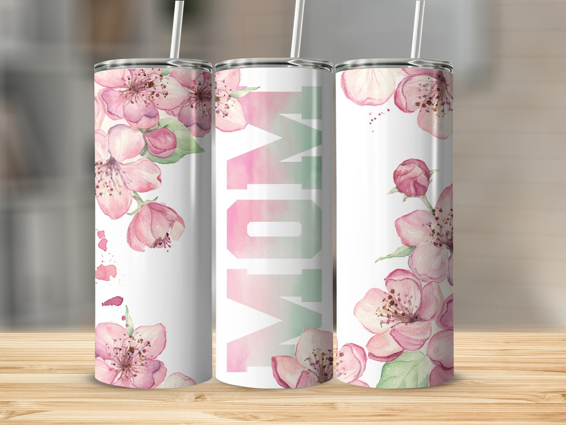 Pink floral tumbler with "MOM" in gradient lettering.