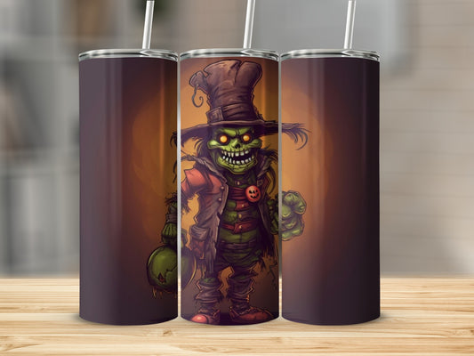 Green monster in a hat and coat holding a pumpkin on a tumbler.