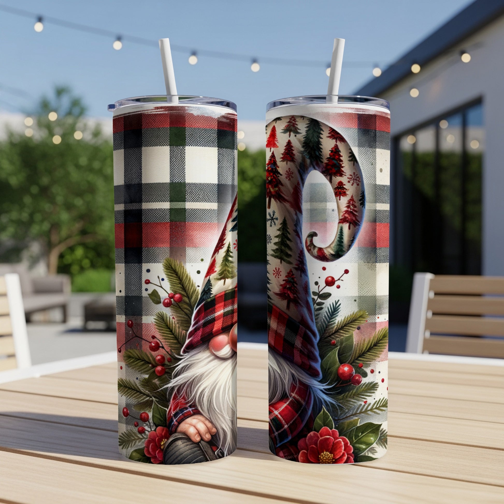Two tumblers with a gnome and Christmas tree pattern on a table.