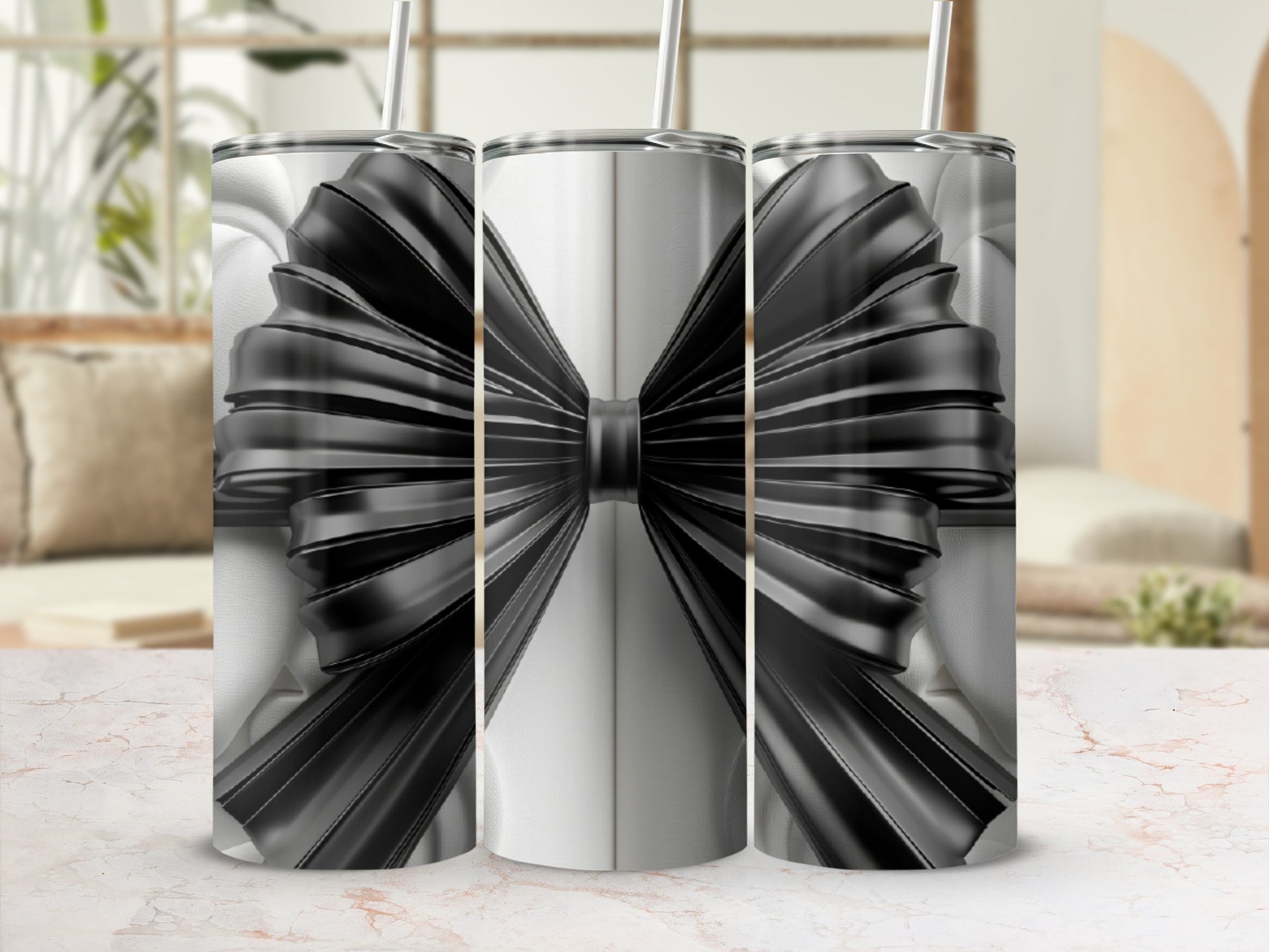 Three tumblers with black ribbon bow design on white background.