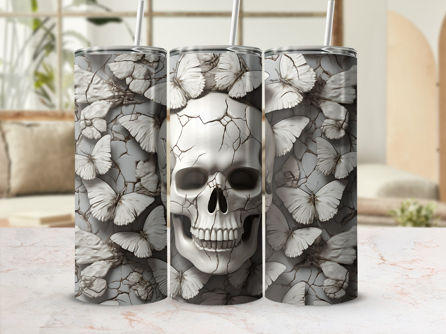 Three tumblers with a cracked skull and butterfly design.
