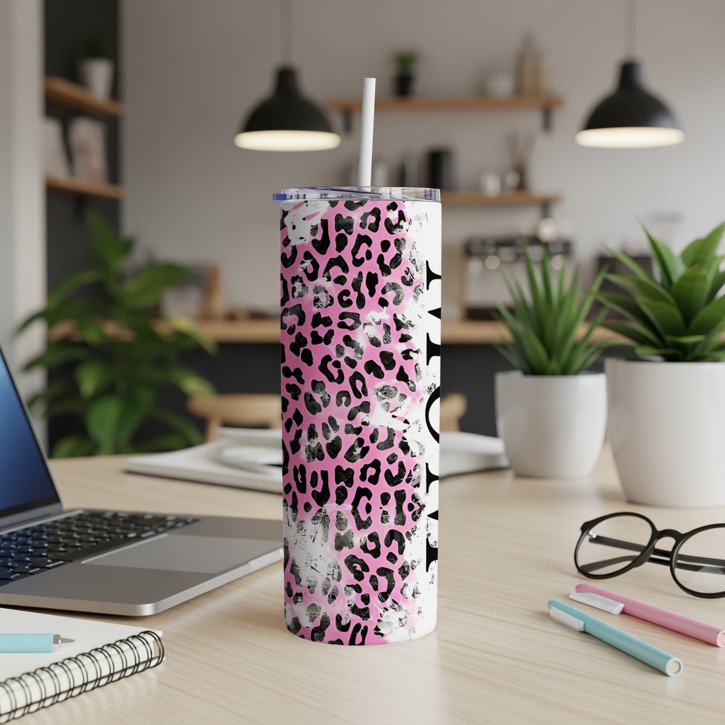 White tumbler with pink leopard print and a black name graphic.