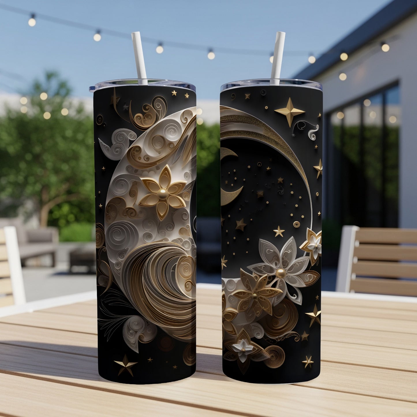 Two tumblers with celestial moon and floral swirling designs and gold stars.