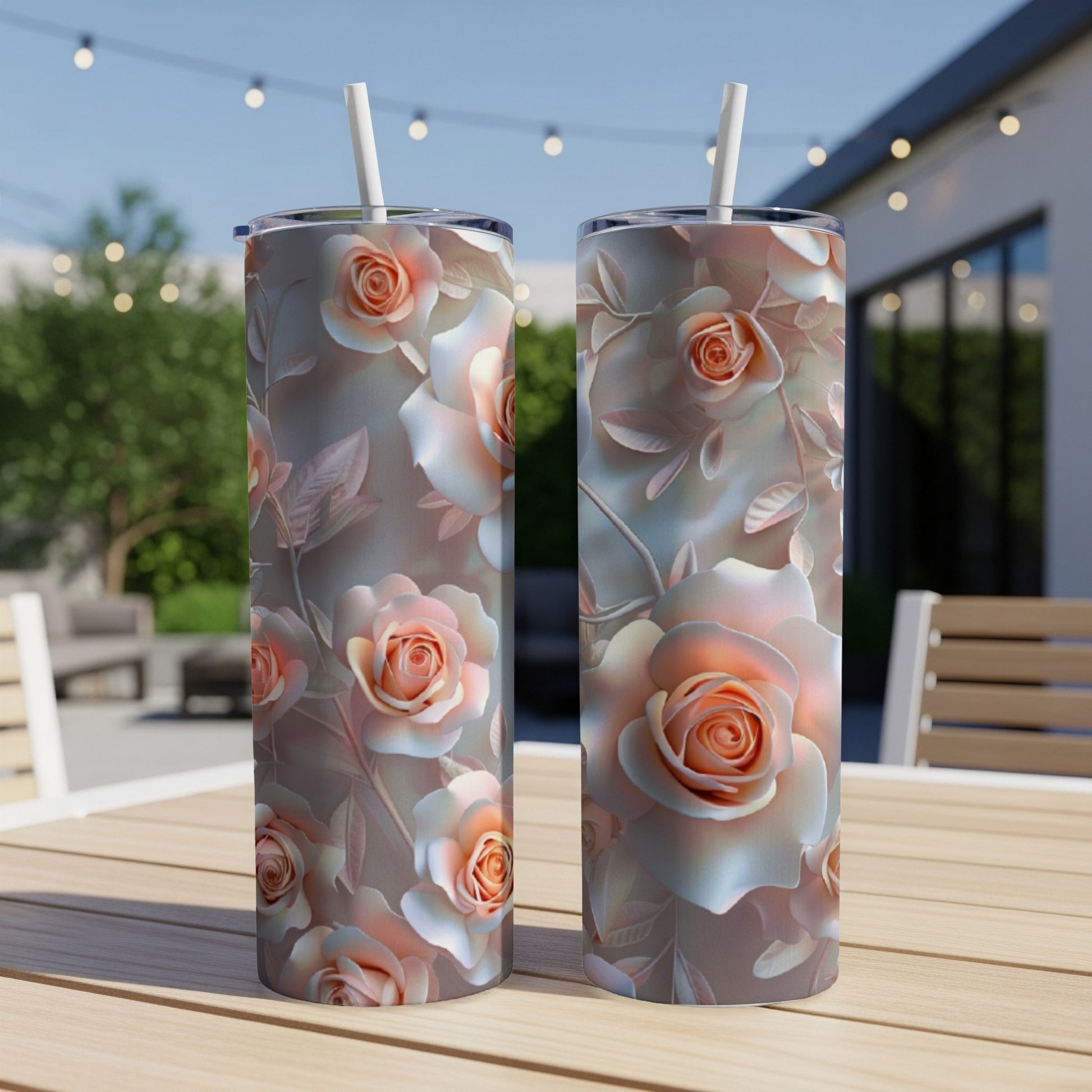 Two tumblers with a pastel rose floral design sit on a wooden table.