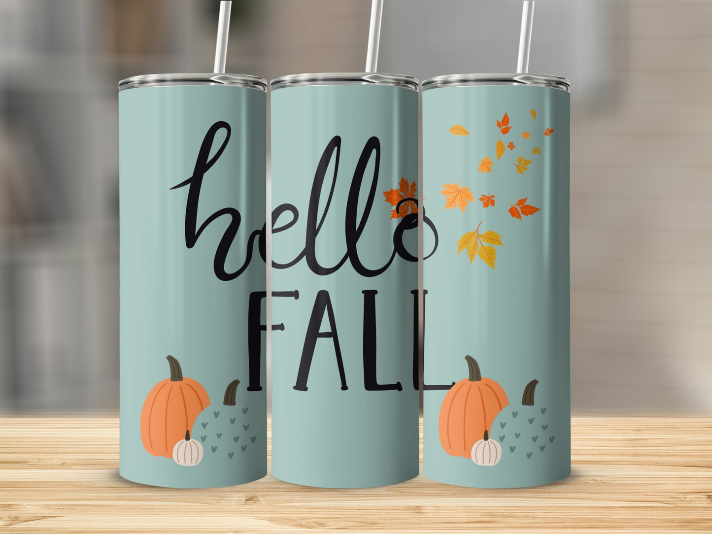 Three mint green tumblers with "hello FALL" and pumpkin designs.