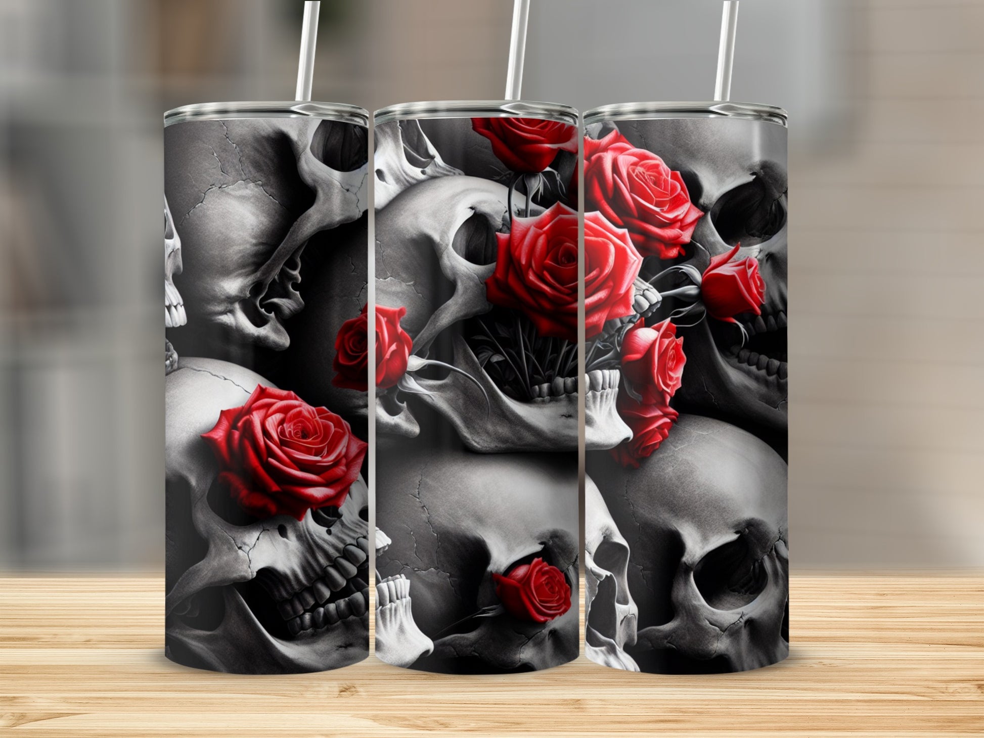 Skulls and red roses design on three tumblers with straws.