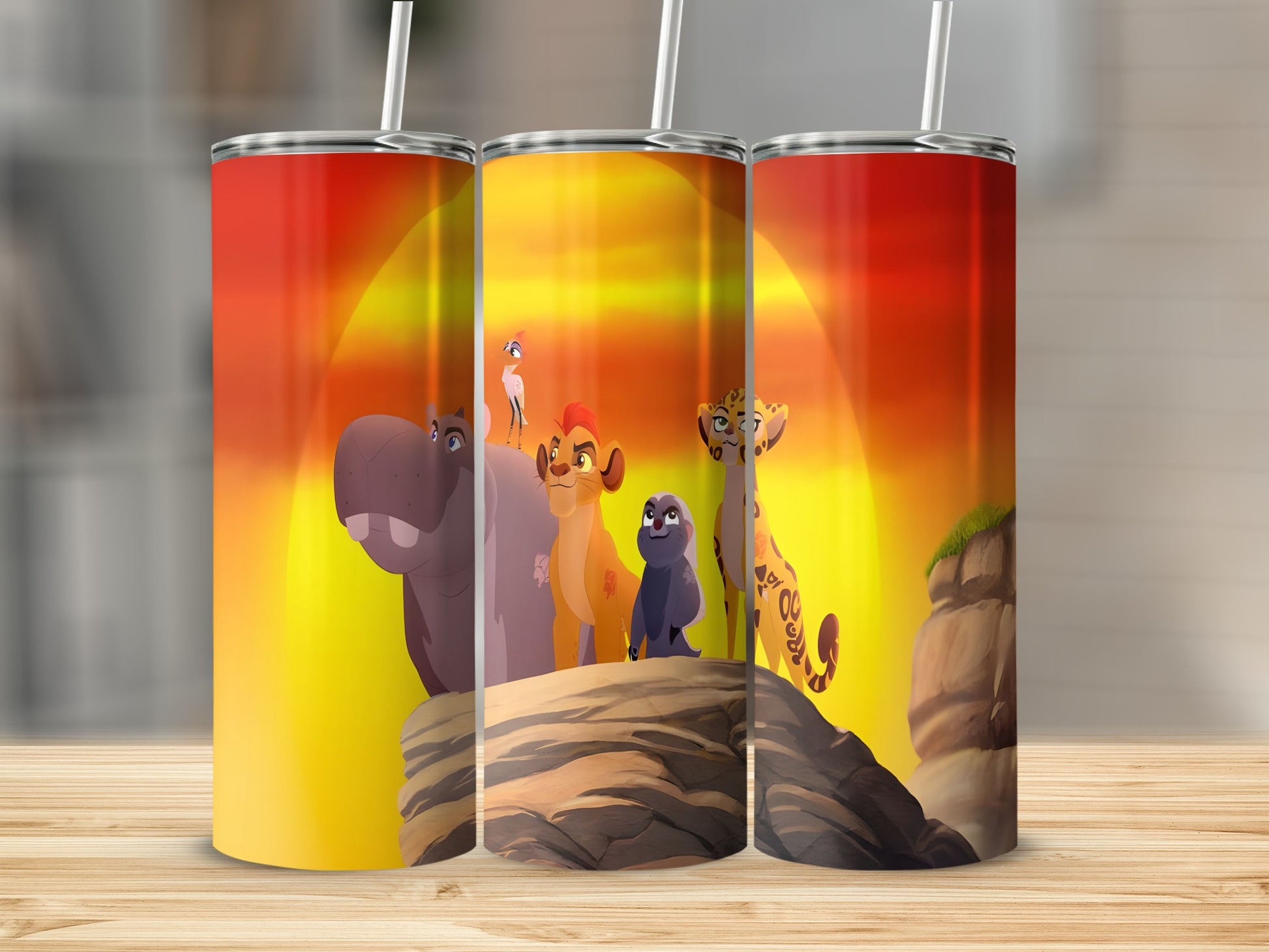 The Lion Guard characters Kion, Bunga, and Fuli stand on a rocky outcrop at sunset.