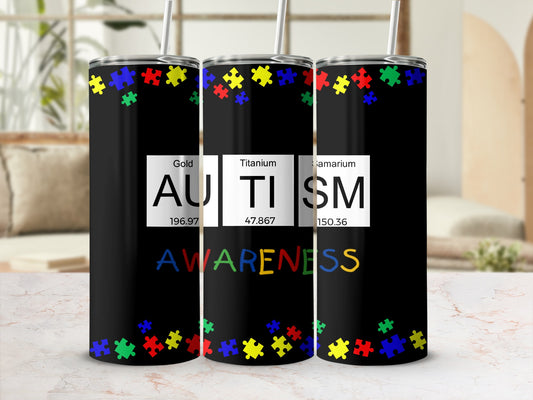 Black tumbler with colorful puzzle pieces and text "AUTISM AWARENESS".
