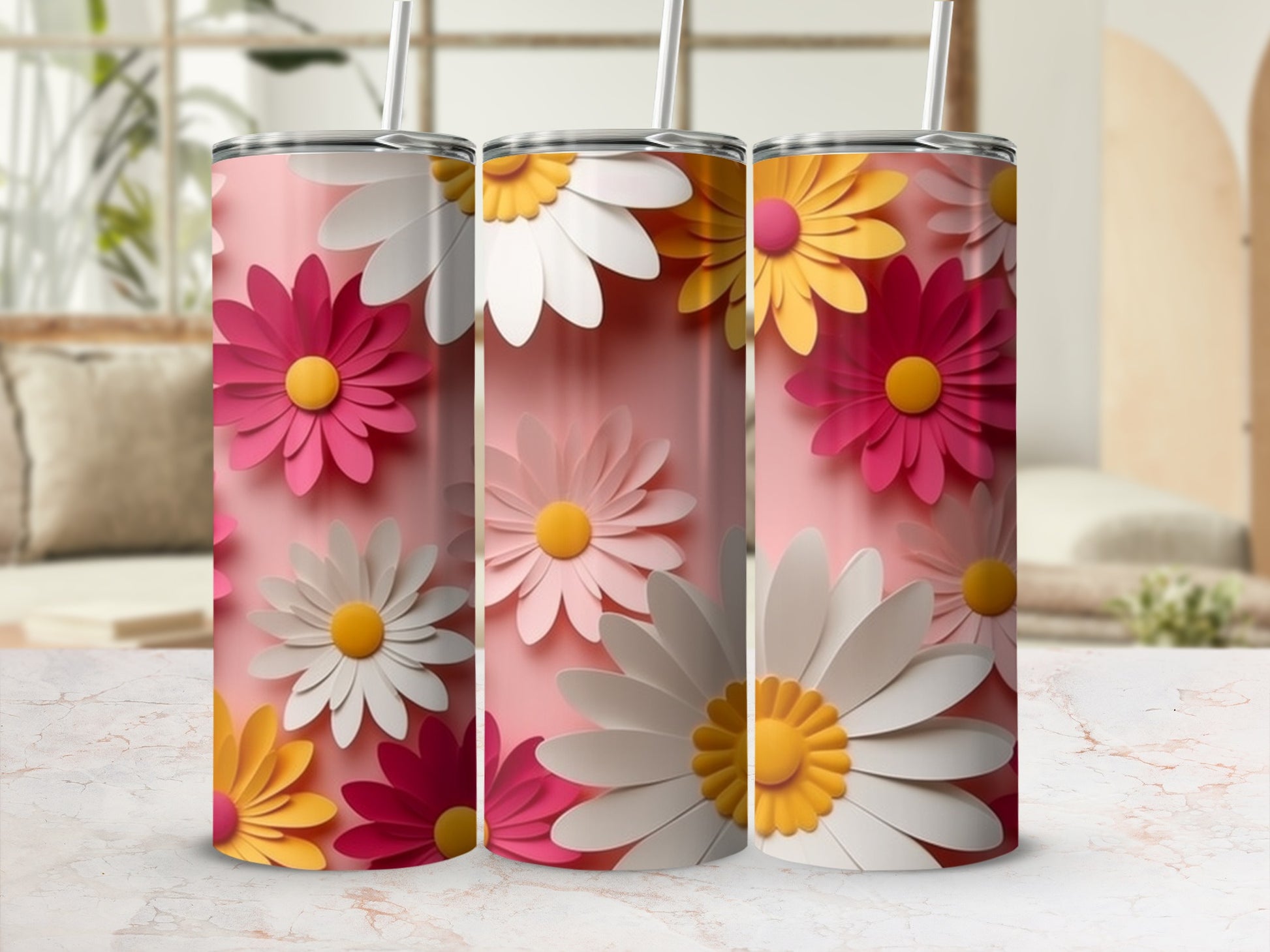 Pink, yellow, and white daisy flowers wrap around three identical tumblers.