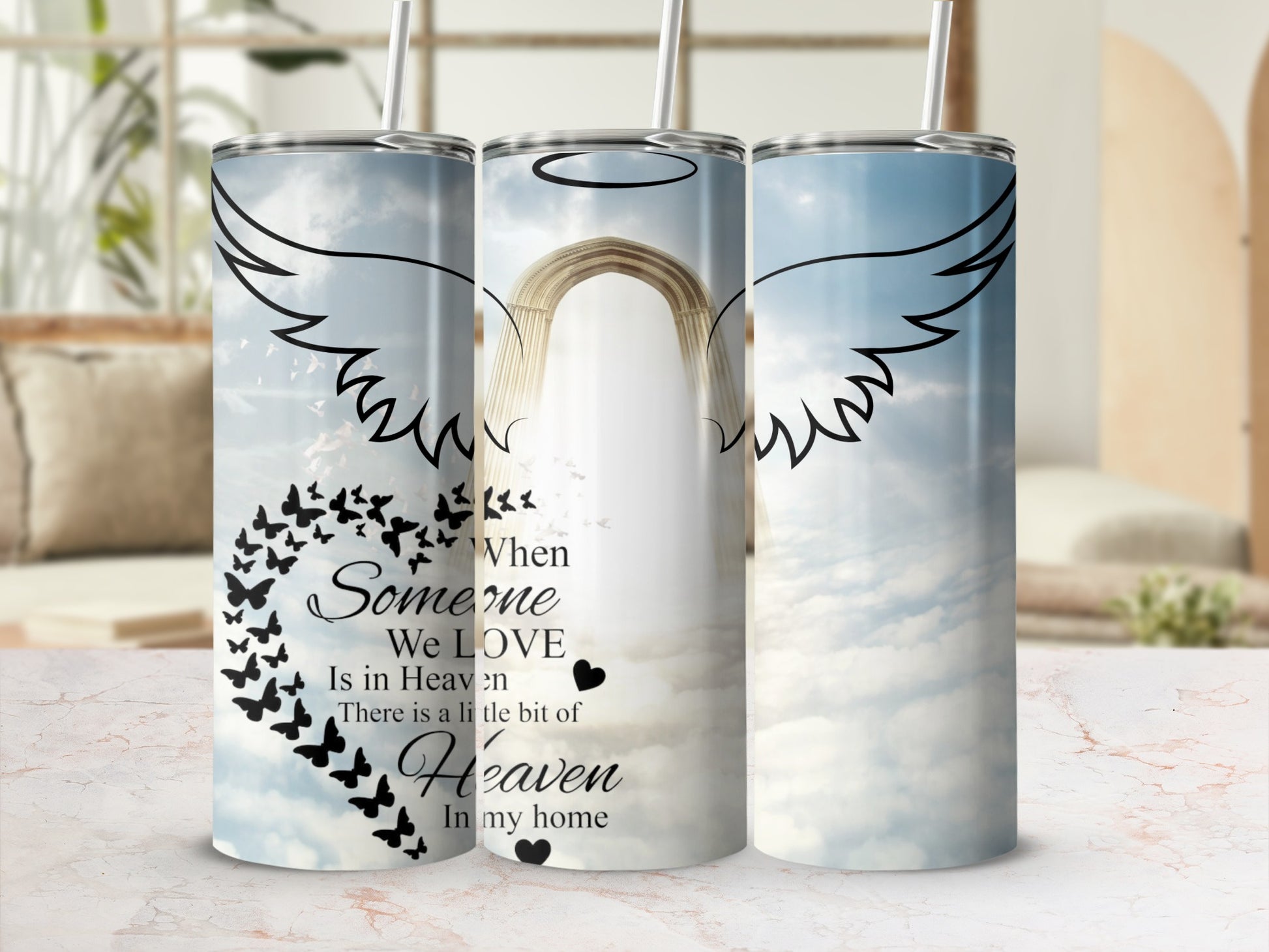 Tumbler with angel wings, butterflies, and text about heaven.