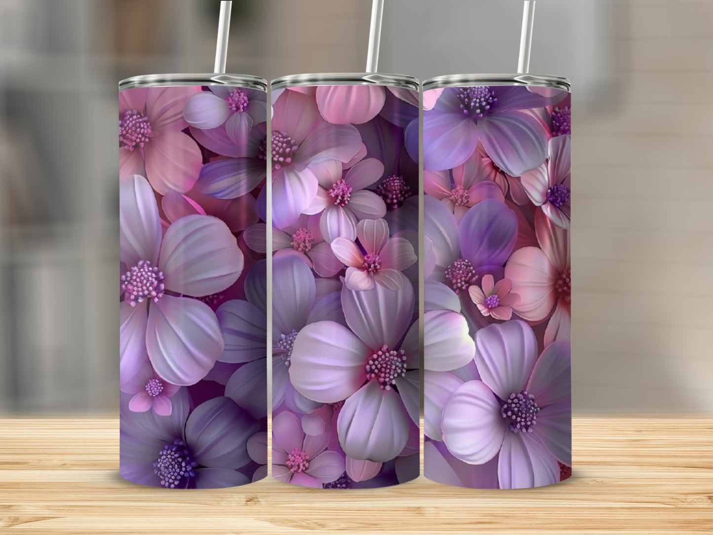 Three tumblers with a purple and pink floral pattern on a wooden surface.