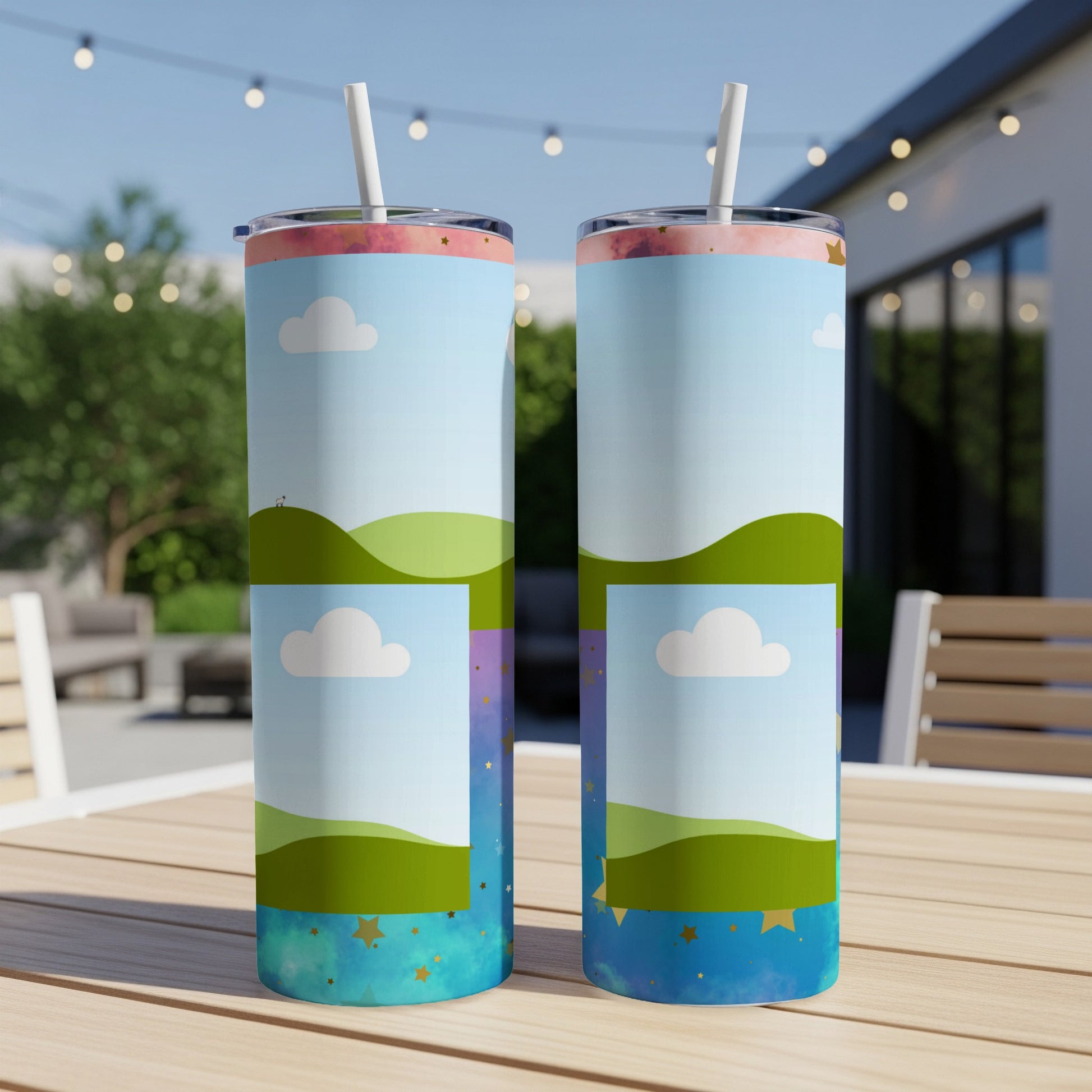 Two tall tumblers with a whimsical sky and rolling hills design.