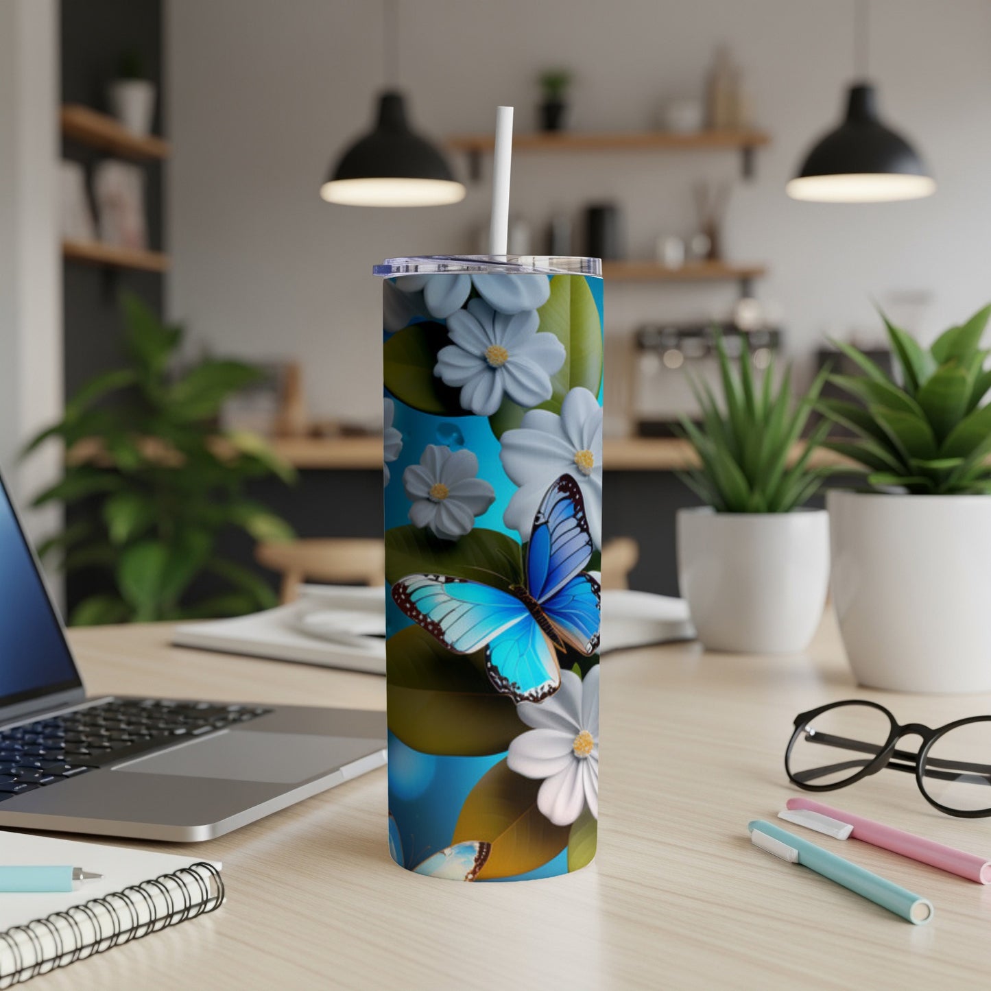 Blue butterfly and white flowers on a tumbler with a straw.