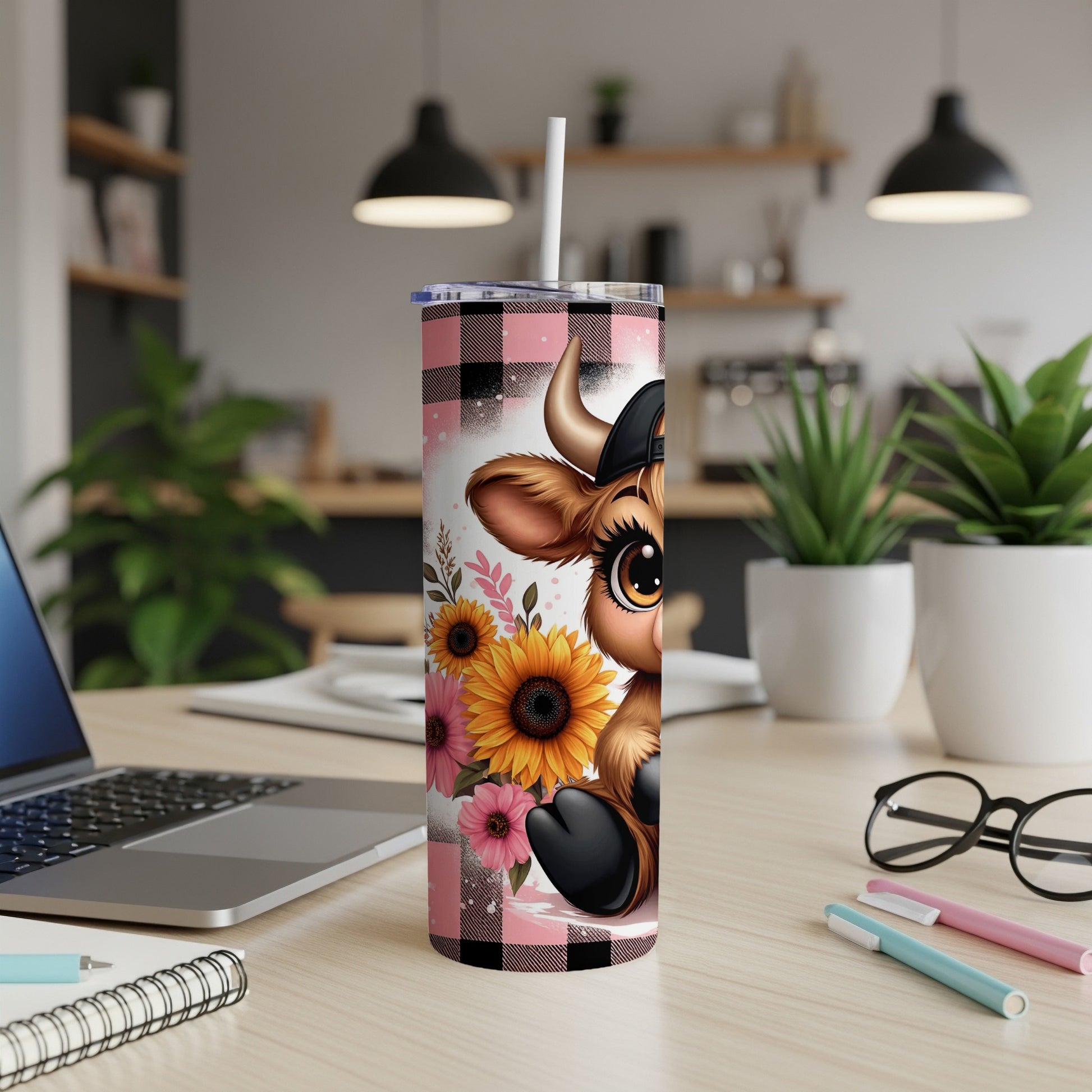 Cute cow wearing a baseball cap, surrounded by sunflowers, on a pink and black buffalo plaid tumbler.