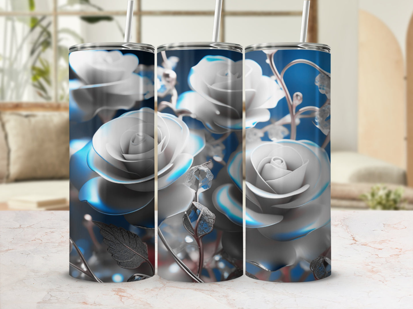 Three silver rose tumblers with blue floral accents on a marble surface.
