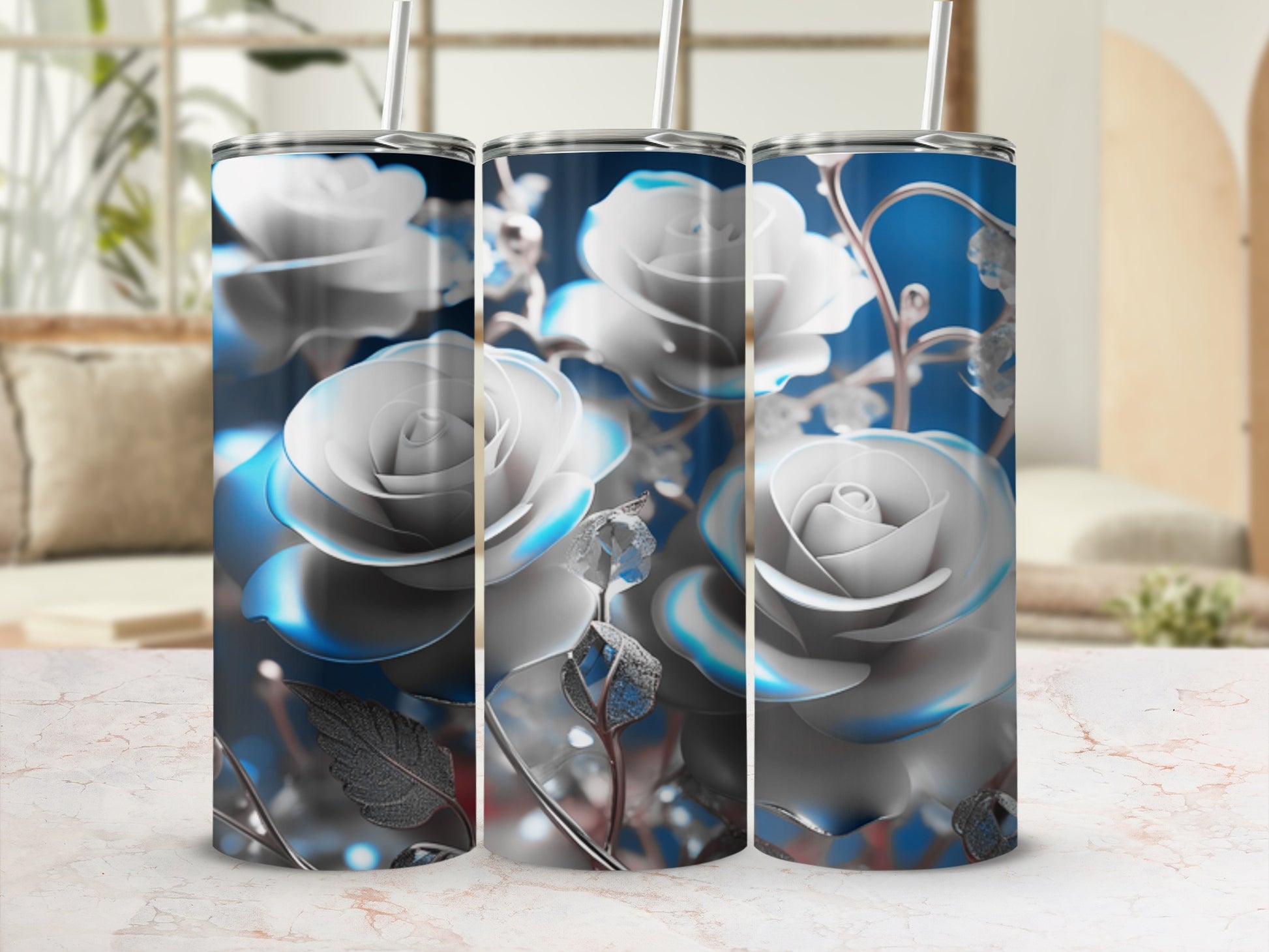 Three silver rose tumblers with blue floral accents on a marble surface.