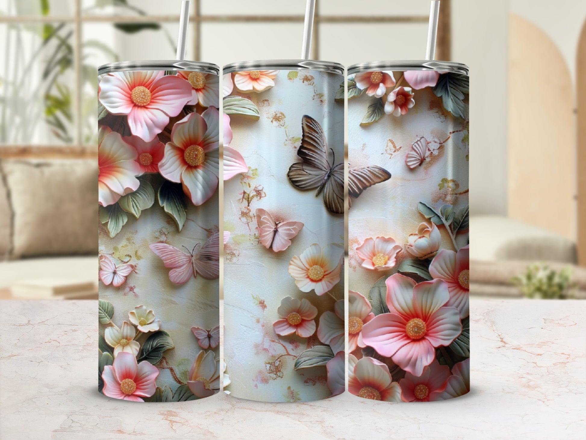 Three tumblers with a floral and butterfly embossed design.