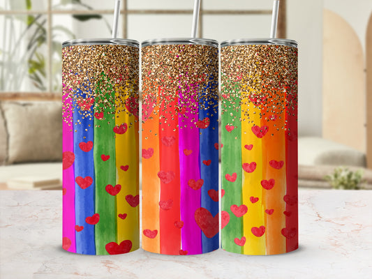 Three rainbow-striped tumblers with red hearts and gold glitter tops.