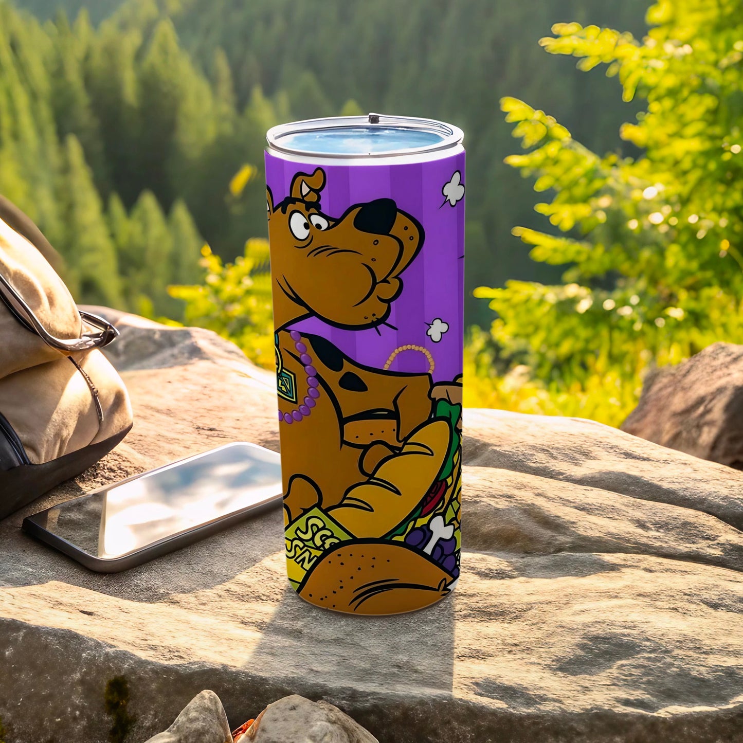 Scooby-Doo on a purple tumbler with a scenic forest background.