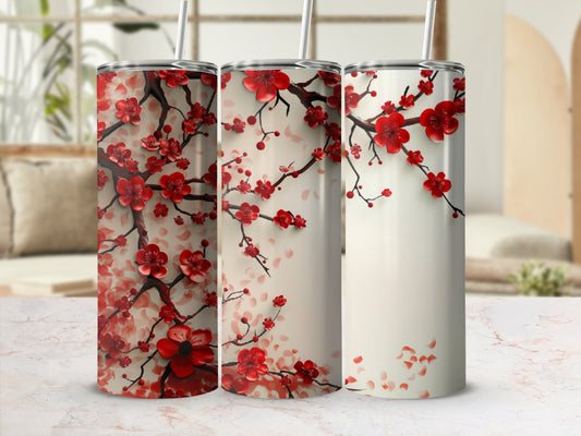 Three tumblers with red cherry blossoms on a marble surface.
